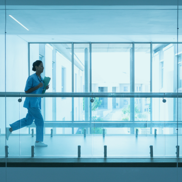 A clinician running down a hospital hallway