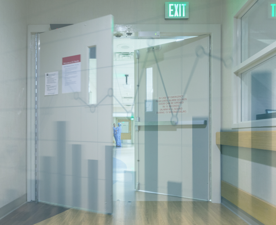 Two opening doors in a hospital hallway, with a data graph icon overlayed